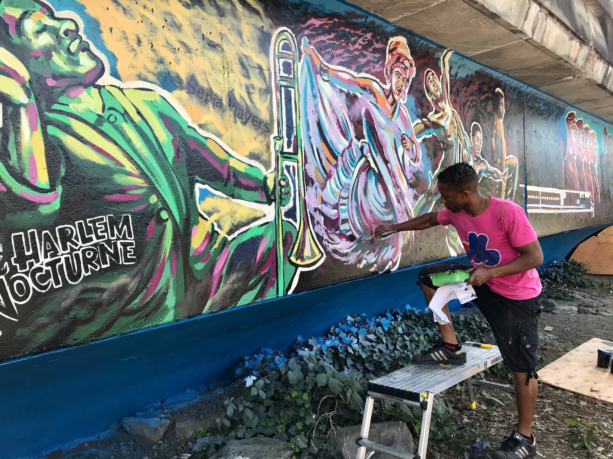 Image of artist, Anthony Joseph, working on his mural commemorating the Vancouver Black community that was displaced.
