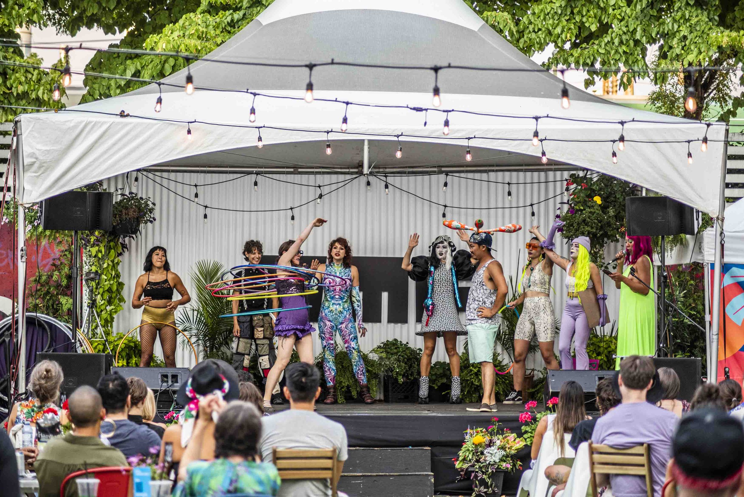 Circus team on stage with hoolahoops