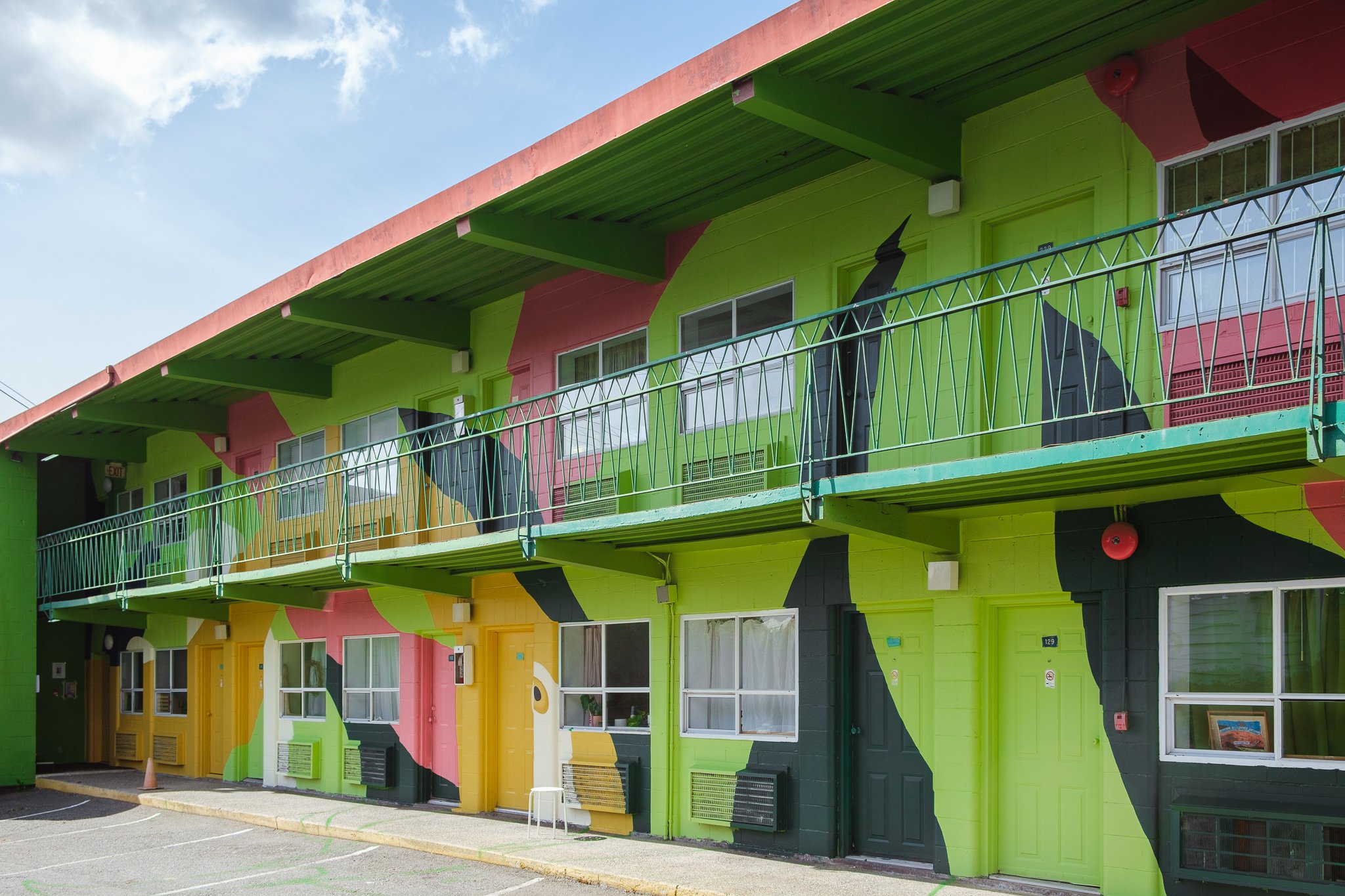 City Centre motel block after mural has been painted, green, pink and yellow abstract shapes, like nature